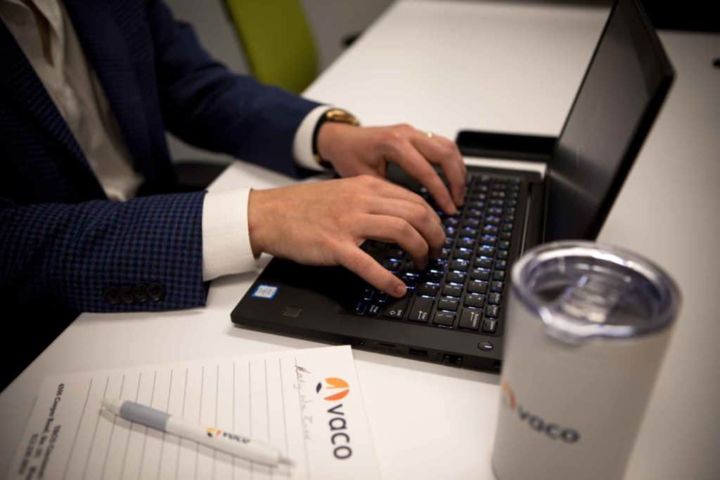 Vaco employee working on laptop
