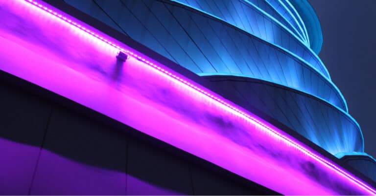 curved office building with fushia neon light